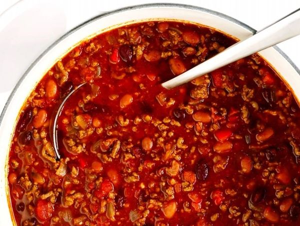 A bowl of hearty chili with ground meat and beans.