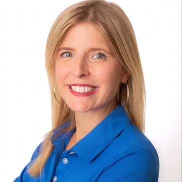 Smiling woman with blonde hair and blue shirt.