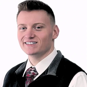 Smiling young man in formal attire.