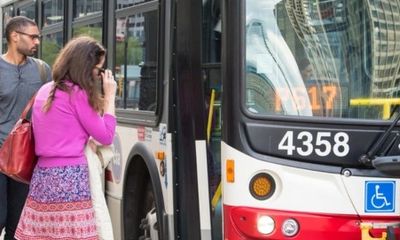 Riders board a bus in Chicago.