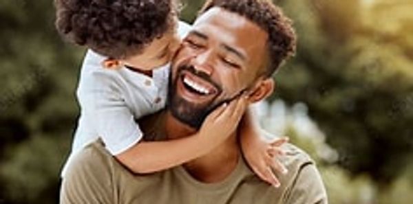 Father and son sharing a joyful moment outdoors.