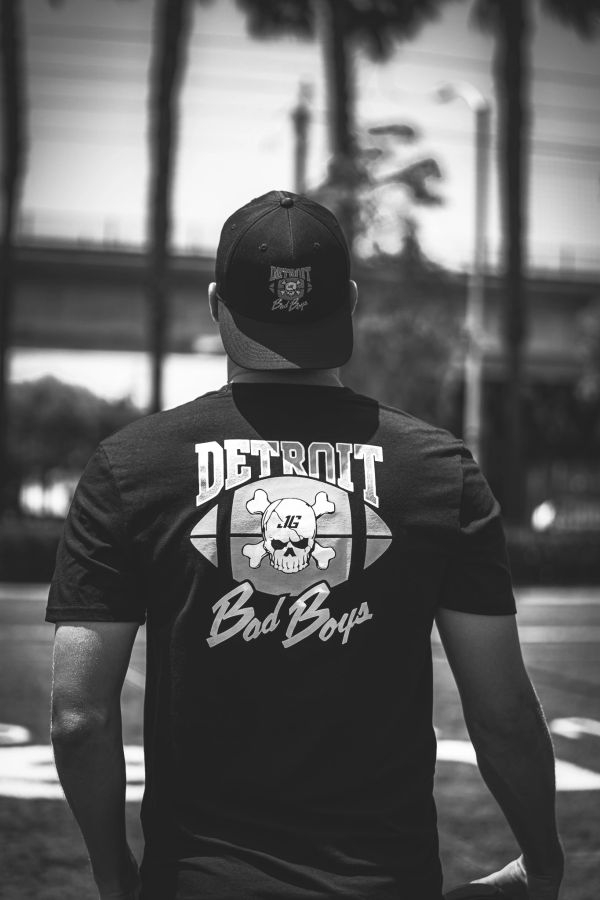 Person wearing a Detroit Bad Boys shirt and cap.