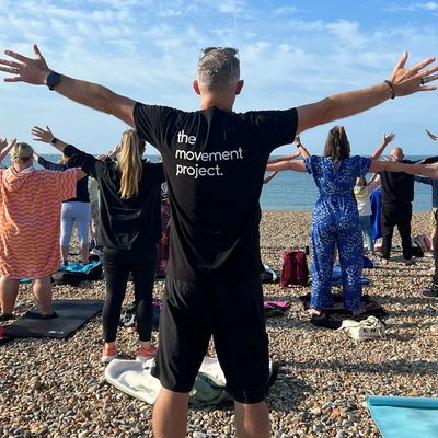 a group of people doing breathwork on the beach