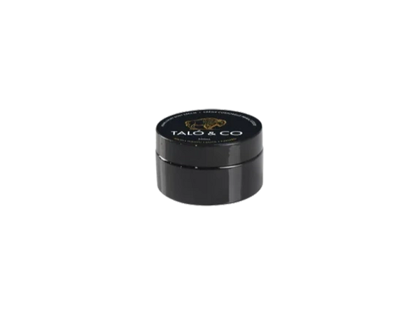 Small black container of TALO & CO skincare product with gold design.