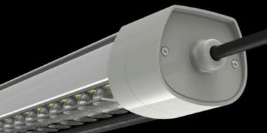 Close-up of a modern LED light fixture with a cable attached.