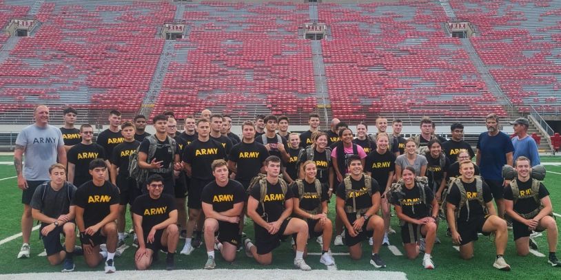 Group photo of young Army cadets on a football field.
