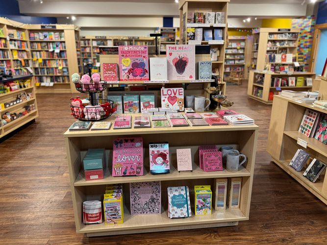 the Valentine's Day display of books, basket of plushies, mugs, and journals at Courageous Books.