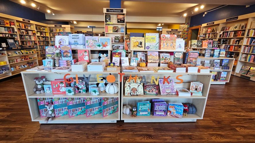 A table of seasonal fall titles greets readers including books, at a indie bookstore in Michigan.
