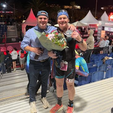 Leslie and Craig @ finish line of Barcelona Ironman