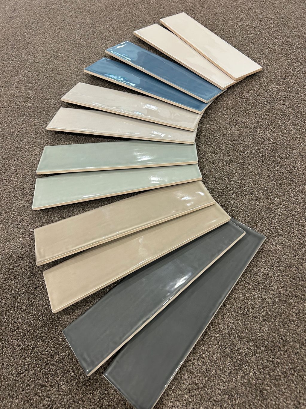 Assorted rectangular ceramic tiles in varying shades.