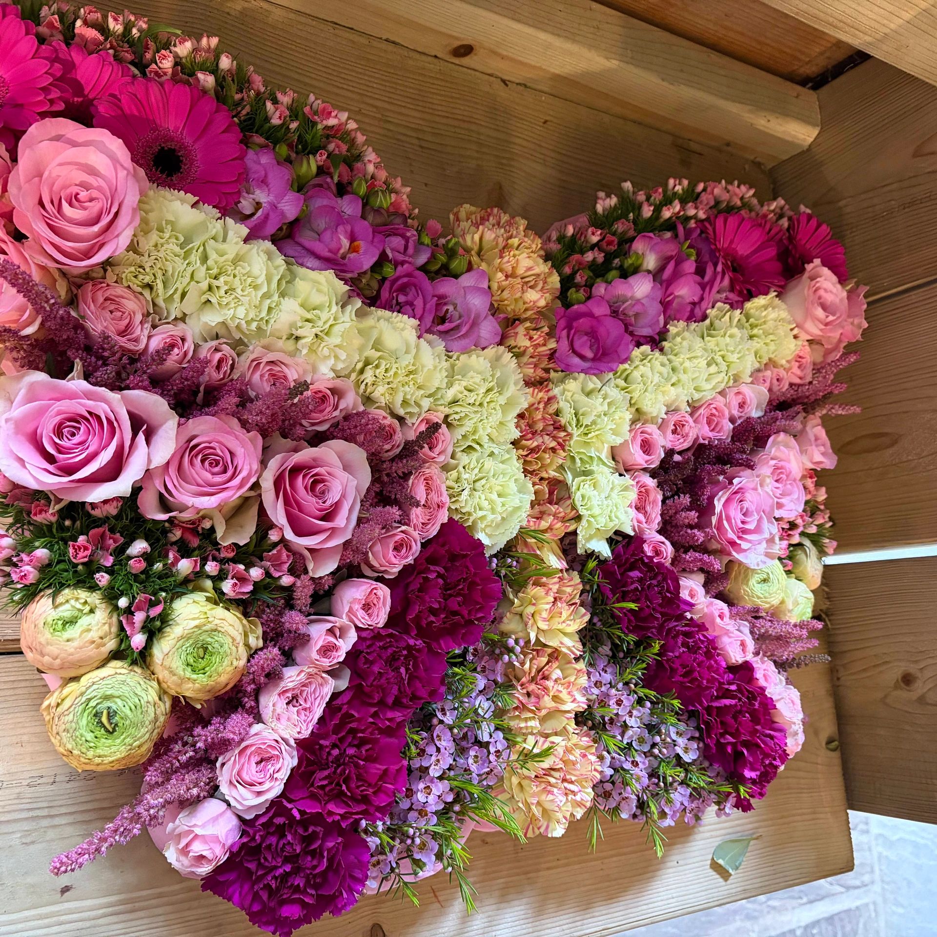 Colorful floral arrangement with roses and carnations.