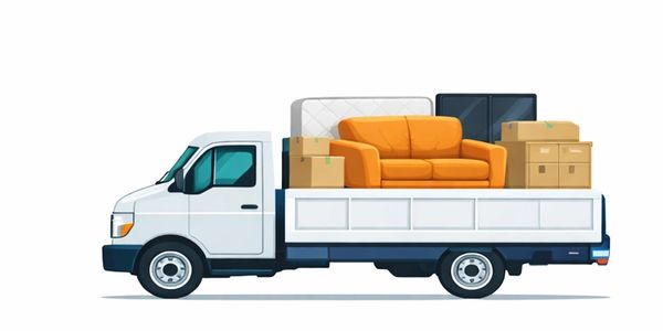 A white pickup truck loaded with furniture and boxes for moving.