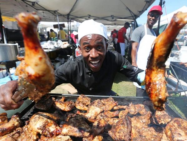 Nicholas Stennett, holding up some Jerk Chicken.