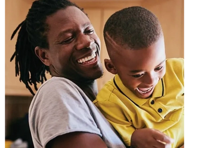 Black male holding his child