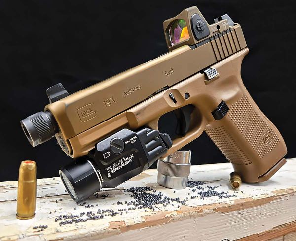 Tan Glock 19X pistol with ammo and accessories.
