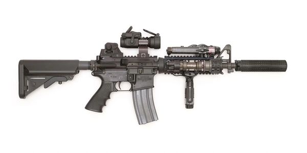 Modern black assault rifle with accessories.