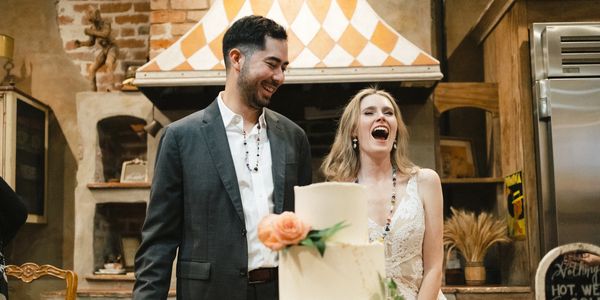Destination Wedding planners help bride and groom prepare for cake cutting 