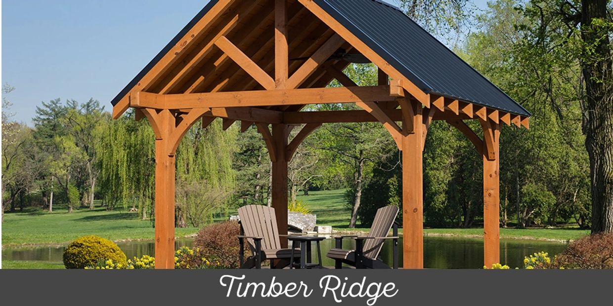 Wooden gazebo with chairs in a park.