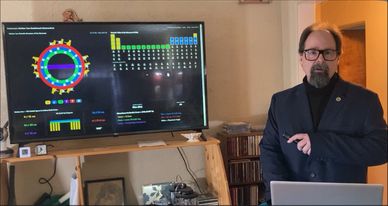 Man presenting scientific data on a large screen.