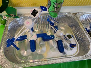 Two small blue and white robots in a tray.