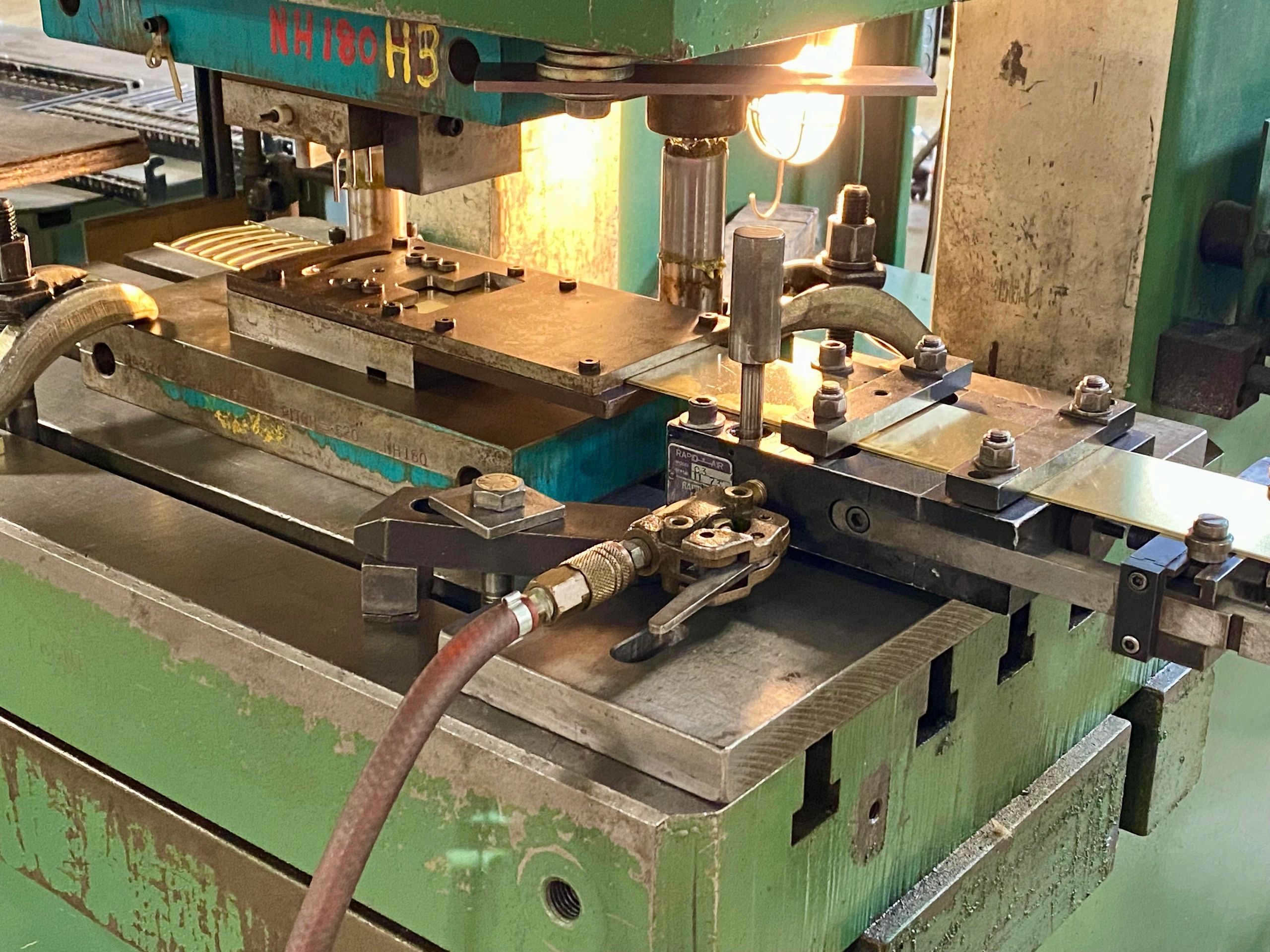 Brass lures blanks being stamped with Harry Lure®️ dies in Maine