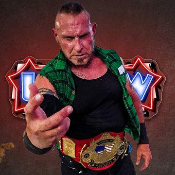 Wrestler with championship belt posing fiercely in front of a wrestling logo.