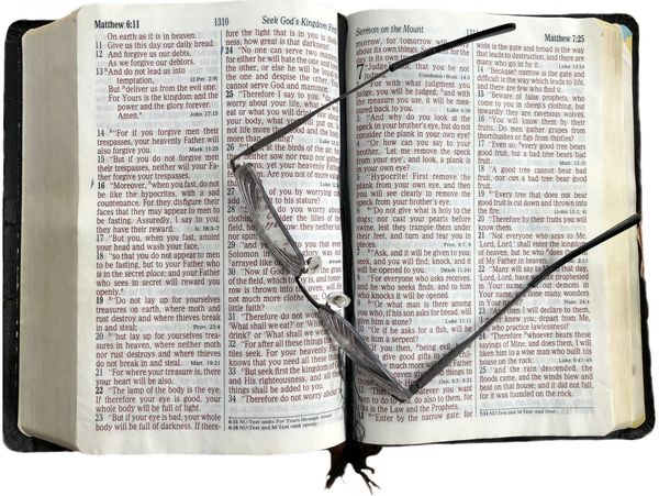 Open Bible with eyeglasses placed on top.