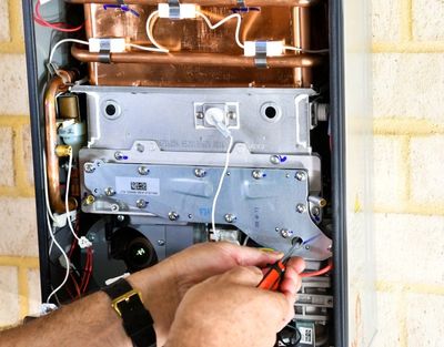 Adjustments being made on a gas boiler being serviced