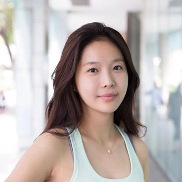 Young woman with long hair and a light tank top.