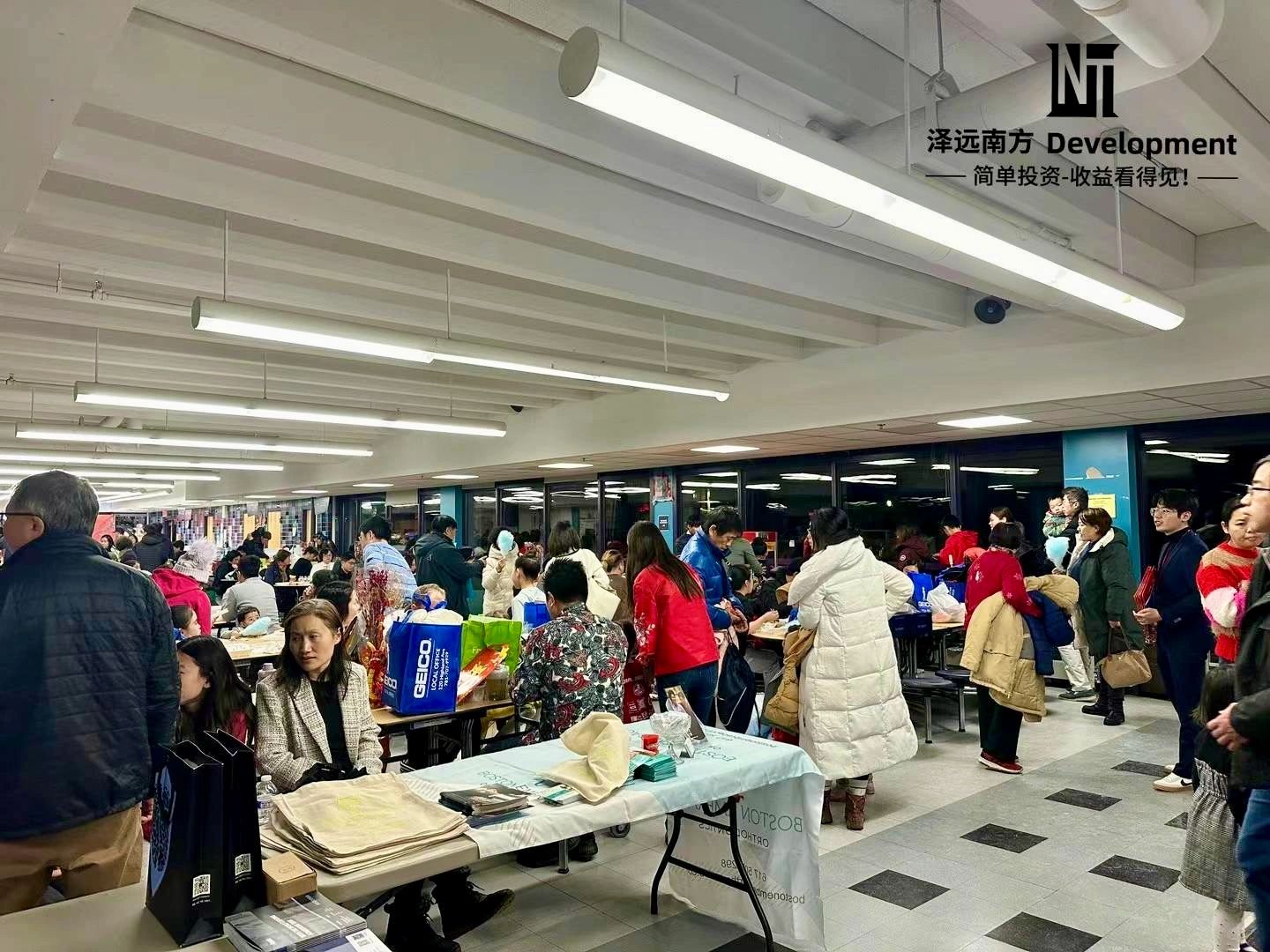Busy indoor event with many people and tables.