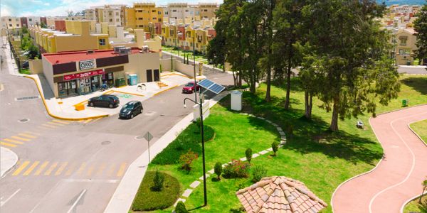 A quiet neighborhood with a convenience store and green park area.