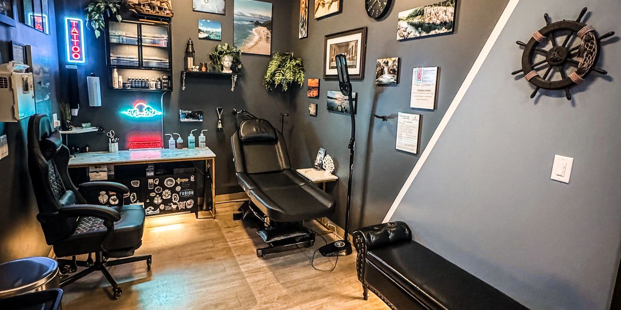 Tattoo studio with leather chairs and nautical decor.