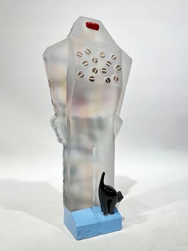 cast glass robot with Mr. Kitty at his feet