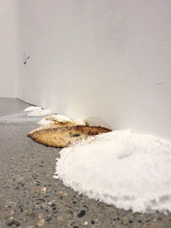 Piles of sodium polyacrylate powder on a gallery floor.