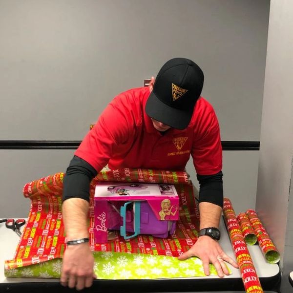 Officer Wrapping Christmas Gifts