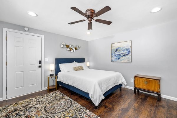 The queen bed and accommodations in The Burgess Room, a furnished studio apartment 