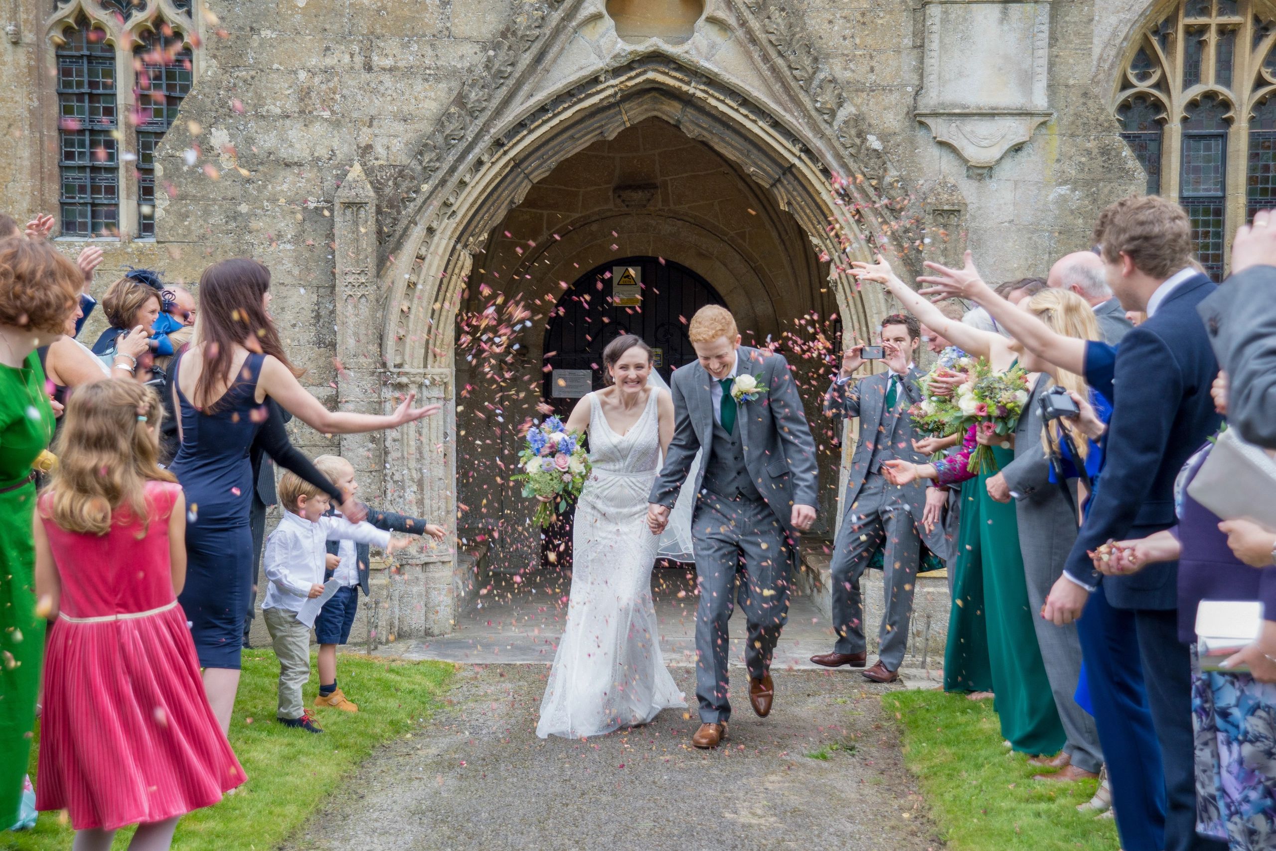 Contemporary reportage natural wedding photograph bride groom confetti Wiltshire candid documentary 