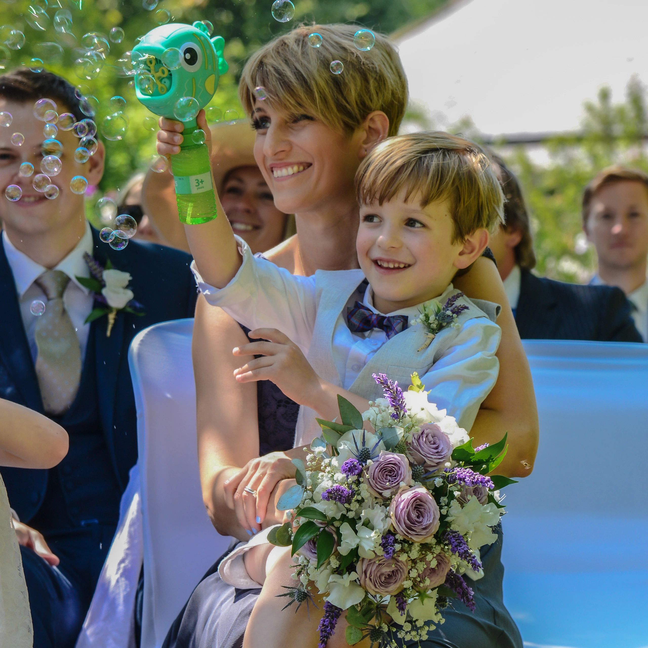 Fun contemporary reportage wedding photo barn wedding Dorset page boy with bubble gun fun photograph