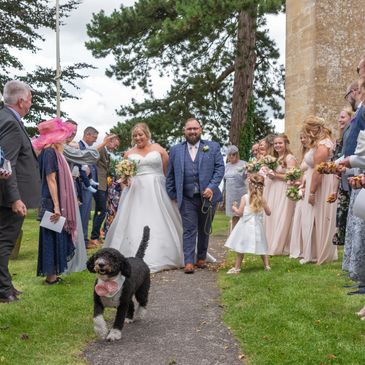 Documentary wedding photography confetti thrown on bride, groom and their dog Pembrokeshire