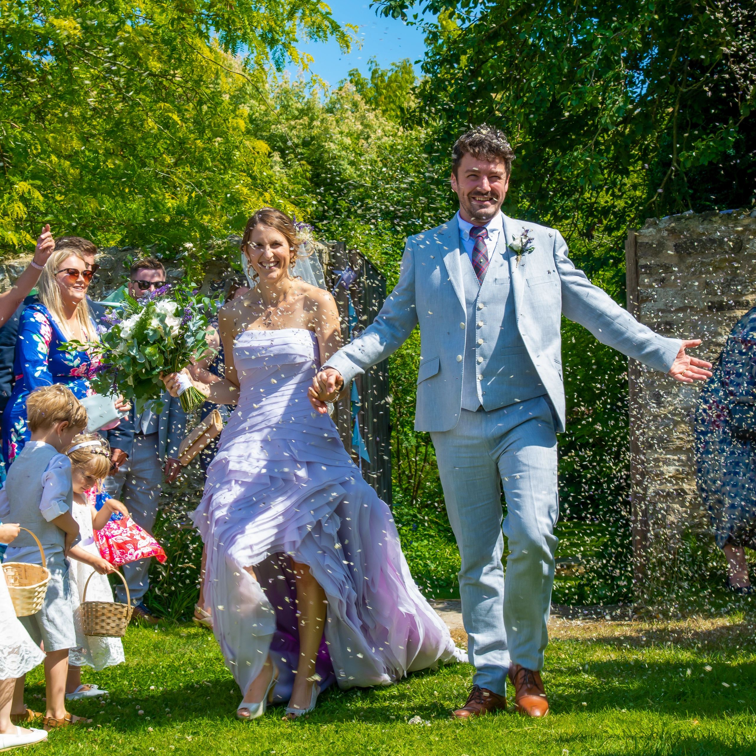 Contemporary reportage natural wedding photograph bride groom confetti emotional candid Dorset photo