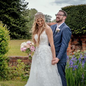 Candid wedding photography bride n groom romantically holds hands and laughing next to iris's Wales