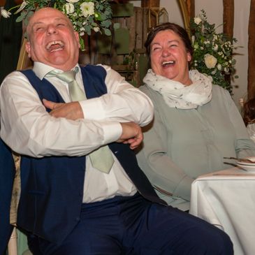 Documentary wedding photography photograph of wedding party people laughing
