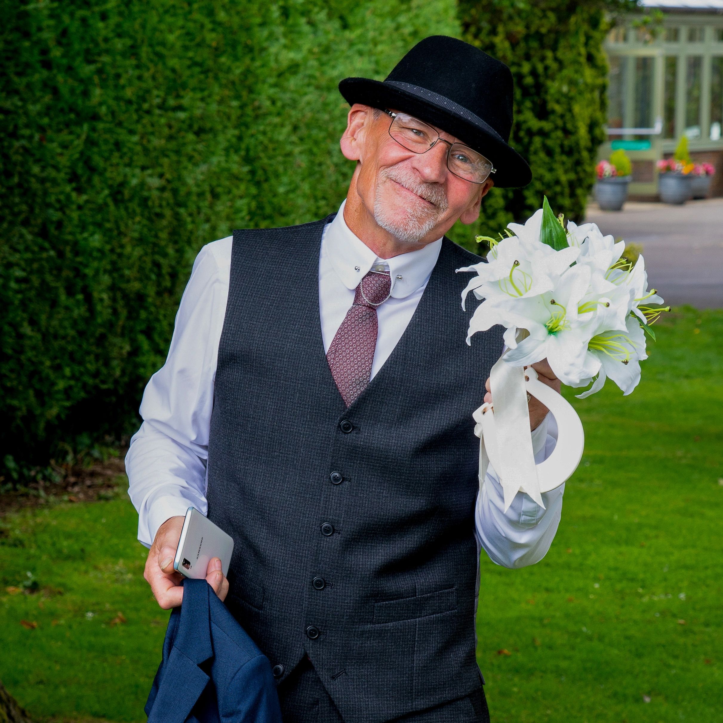 Wedding Wiltshire photography father of the bride holding bouquet of wedding flowers contemporary 