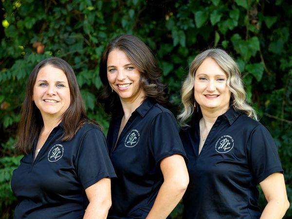 The all-women executive team of Strength In Numbers Co. wearing their team shirts in outdoor setting