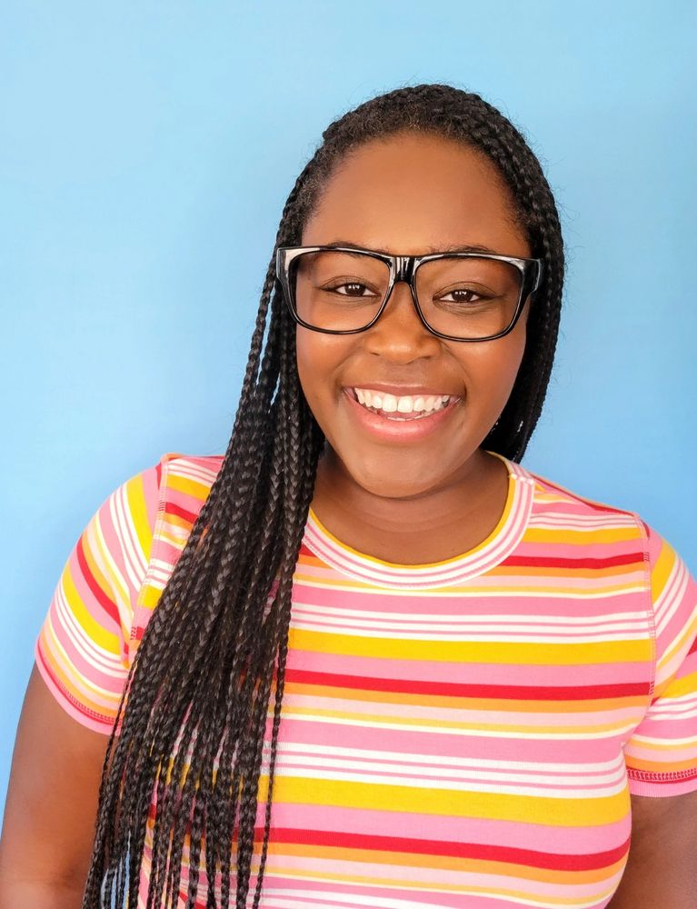 Jasmine Reid smiling for commercial headshot; content creator and actor