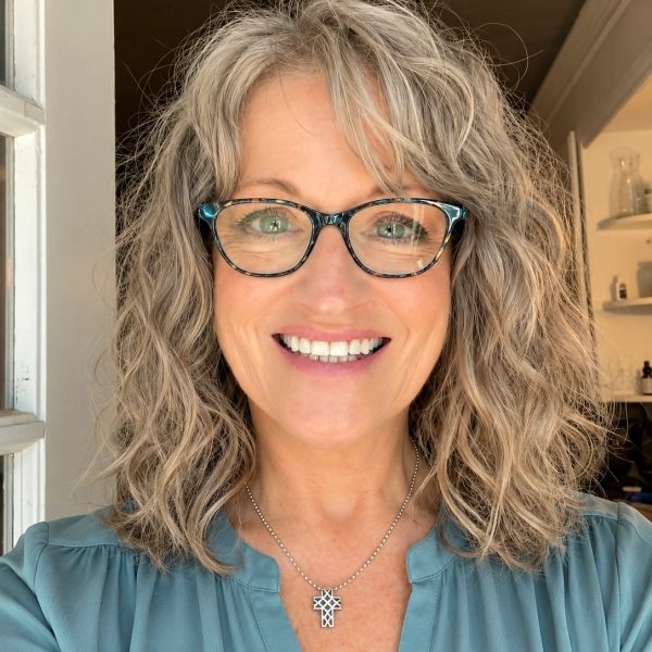 Teri Miller in a pale blue blouse smiling 