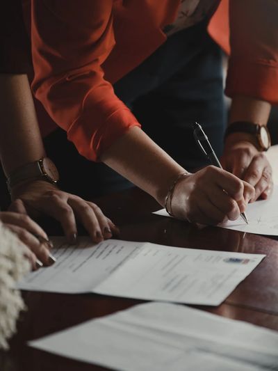 Two people signing documents