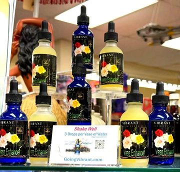 Bottles of Vibrant Vase Enhancer on display.