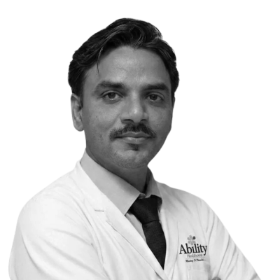 A man in a white coat and tie looking confidently.