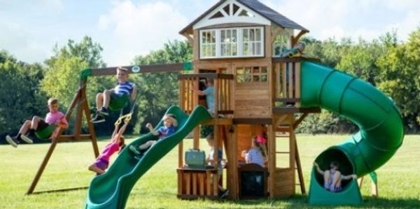 Picture shows a swing set with two slides, a club house, two swings and a trapeze bar.
